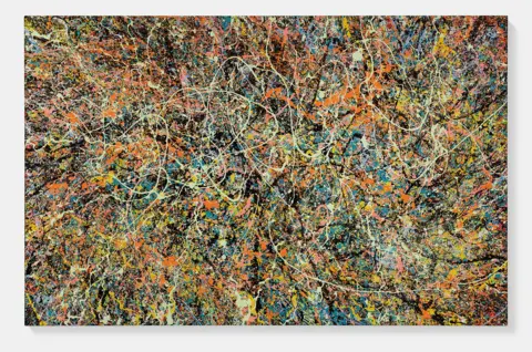 Prudence Cuming Associates Ltd/Ed Sheeran A photograph of one of Ed Sheeran's canvas paintings. It is a black canvas that has been splattered with paint of all different colours.