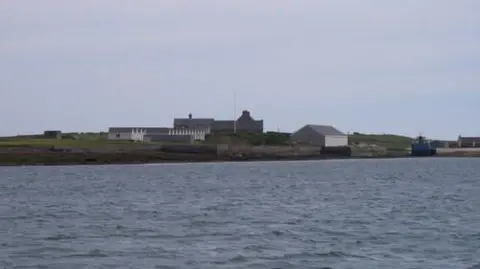 Dave Simpson/ Geograph A collection of buildings on an island. 
