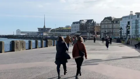 BBC People walking on Douglas Promenade