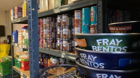 A food bank with canned food on shelves