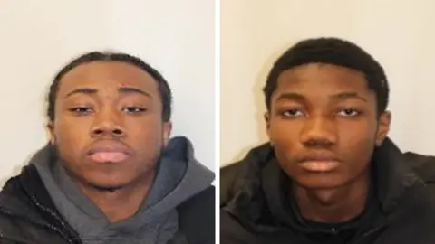 Met Police Met Police mugshots of Shilioh Hinds and Camron Osei. Both are wearing dark clothing and are looking directly towards the camera lens. Both ahve short dark hair.