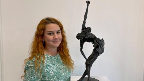 Abigail Molenaar with the sculpture