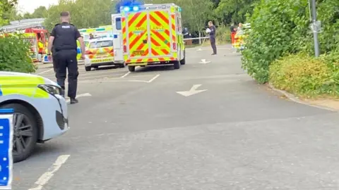 Rachael McMenemy/BBC Several emergency service vehicles parked near the incident