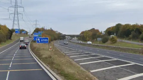 The A1(M) junction at Letchworth Garden City. Several vehicles can be seen on the road and a slip road, signposted A505.