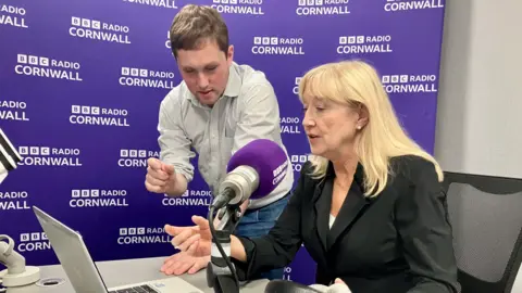 A man and a woman in a radio studio