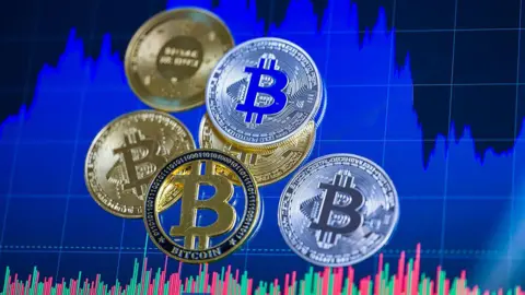 Graphic showing Bitcoins in gold and silver coin form against a blue background