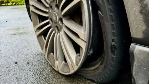 Dave Fishwick An image of a damaged tyre, with the alloy hanging off the wheel.