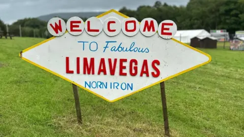 Daryl Harkin A white sign that reads: 'Welcome to fabulous Limavegas Norn Iron'