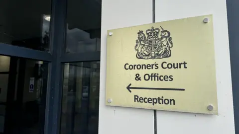 George King/BBC News A sign for the Coroner's Court