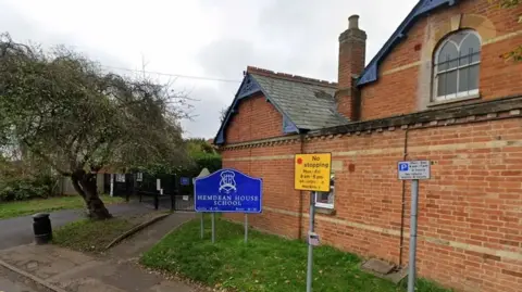 A Google Maps general view picture of the school site, a two-storey brick building on the side of a residential road.