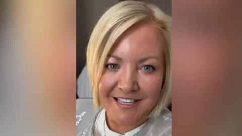 Rhonda Carey A blonde woman with a sequinned top on