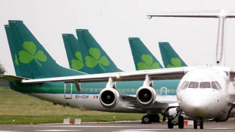 Aer Lingus planes line up behind white plane