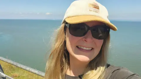 Louise Christiaans Louise at Hurlestone Point wearing a cap and sunglasses