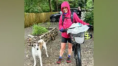 Lindsay Buck with her bike with the basket full of rubbish