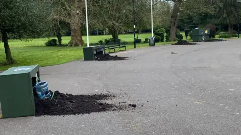 Friends of Central Park Toppled over bathtubs with soil on the ground 