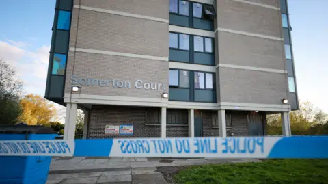 ASP Police tape in front of building which says Somerton Court on it