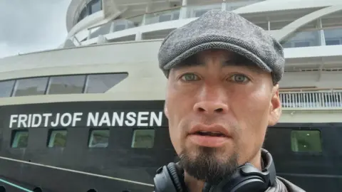 Aleqatsiaq Peary Aleqatsiaq Peary infront of a large ship