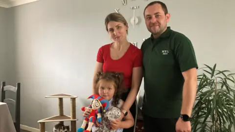 Vladymyr and Alina Tkachenko with their daughter Zlata 