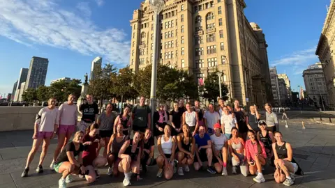 Steph Barney A group of around 30 women gather together to pose for a photograph in Liverpool, they are all wearing running gear