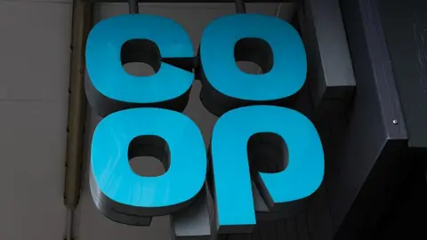 The blue Co-op logo shown on a sign outside a shop