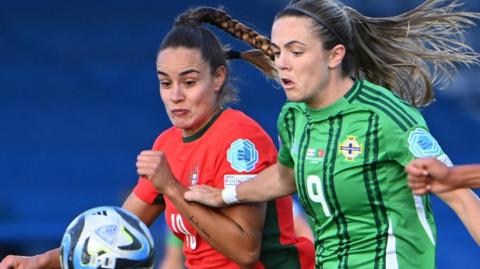 Portugal's Diana Gomes and Northern Ireland striker Simone Magill in a race for the ball