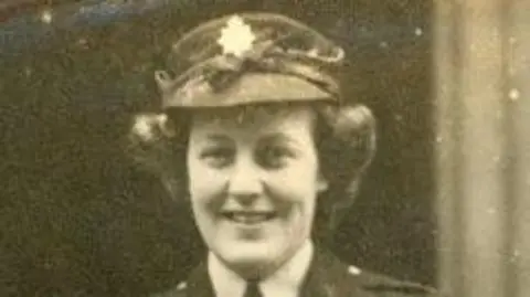 Gillian Tanner is pictured as a young woman in uniform in a black and white photograph