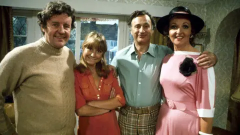 The four main characters in The Good Life - Richard Briers, Felicity Kendal, Paul Eddington and Penelope Keith are seen in character posing for the camera.