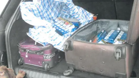 LDRS A suitcase full of illegal contraband in the back of a car