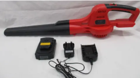 Suffolk Trading Standards One of the leaf blowers. It has a black nozzle and a red handle and body. Its electrical plug sits in front of it.