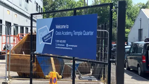 The sign on the fence outside the Oasis Academy in Temple Quarter, Bristol