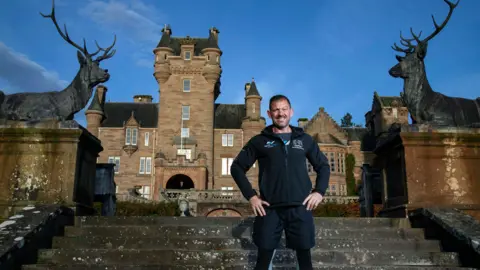 John Baikie Photography Andrew Jenkins stood on the steps outside Ardross Castle