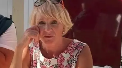 LDR Sarah in summer dress wearing sunglasses