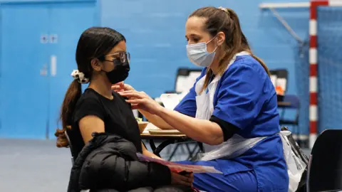 A student receives the Meningitis B vaccine at the University of Kent sports hall on March 19, 2026 in Canterbury, England.