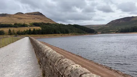 Local Democracy Reporting Service A walled concrete pathway with the reservoir to the right