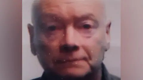 A passport photo of Steven Caulfield, with a neutral expression