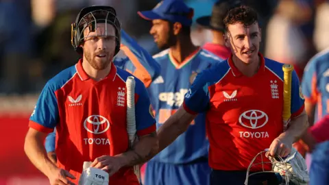 England's Harry Brook and Phil Salt celebrate after victory over India