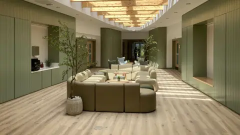 BBC/Cara Thorpe The central room of Overgate Hospice is pictured. There is a table surrounded by comfy sofas and chairs, while two small potted trees are on either side. The colour scheme is pale green - this is on the walls, chairs and sofas. There are wooden beams along the ceiling of the room, where the sun is shining through.