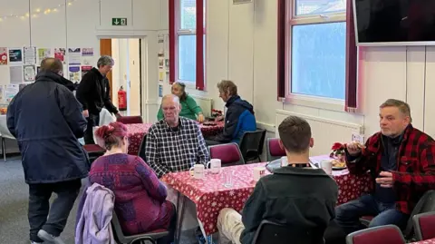 People at The Winter Warm Welcome session at The Salvation Army in Sheerness enjoying a hot drink and chat