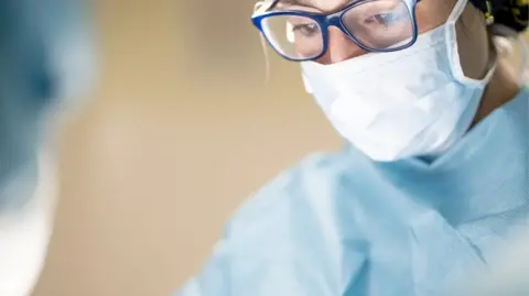 Getty Images Surgeon in a mask