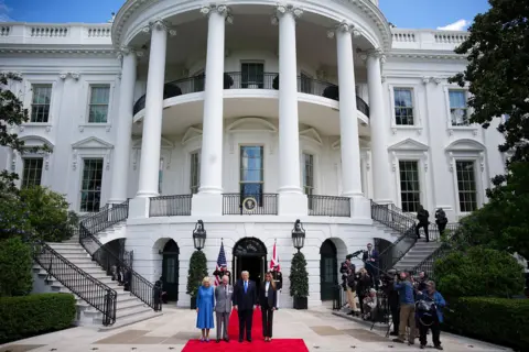 Getty Images Queen Camilla, King Charles III, U.S. President Donald Trump and first lady Melania Trump pose during a farewell ceremony at the White House on the final day of the state visit of King Charles III and Queen Camilla on April 30, 2026 in Washington, DC. 