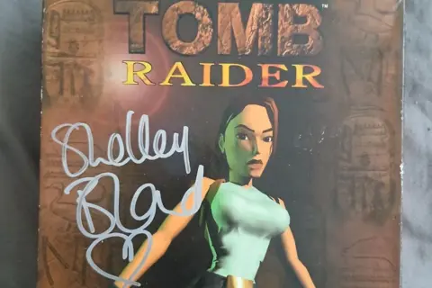Amy Dyson The cover of the originally Tomb Raider game signed by Shelley Blond, the original voice actor of Lara Croft