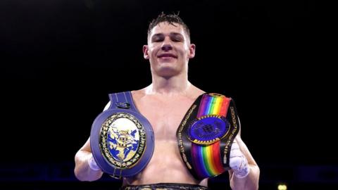 British boxer Chris Billam-Smith holding two belts
