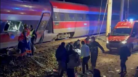 First responders search through wreckage after two high-speed trains derailed in Adamuz