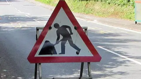 A generic image of a triangular red and white roadworks sign, as typically seen in the UK