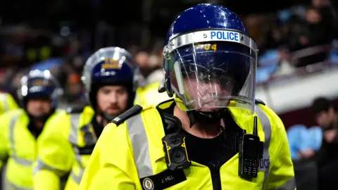 PA Media Police with hi-vis jackets on and protective head gear on during the UEFA Europa League, league phase match at Villa Park, Birmingham