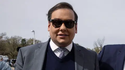 Getty Images George Santos wearing a suit and sunglasses