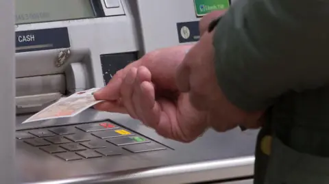 PA A person withdrawing cash