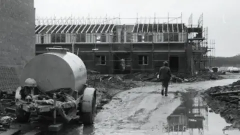 A black-and- white image showing a construction site in the Oakwood area of Birchwood in 1981.