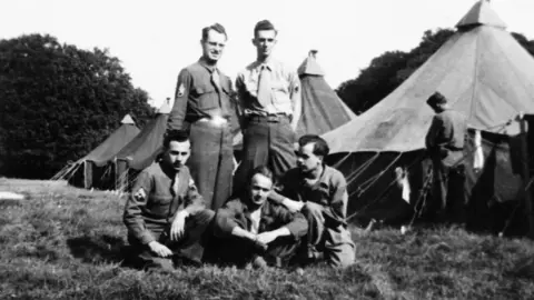 Albert Beaney A black and white photograph of US Army soldiers - likely to be 101st Airborne Division - with Lydiard Park Camp tents in the background.
