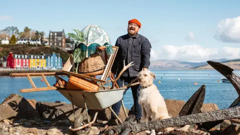 Banjo Beale Banjo and Grampa the dog with a wheelbarrow-load of treasures on Mull